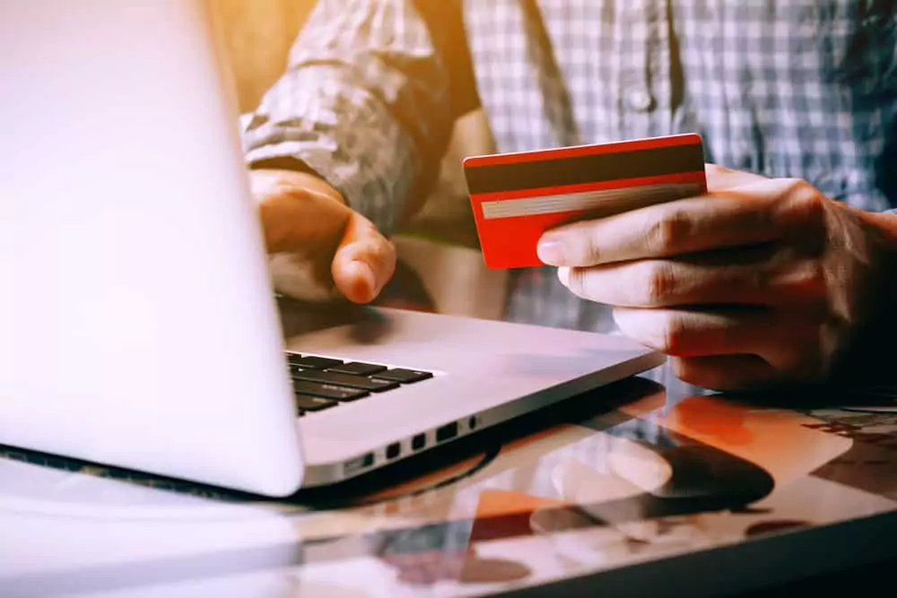 business man on laptop with credit card